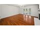 Spacious living room features hardwood flooring, white wall paneling and a fireplace with French doors to the pool at 13004 Bell Creek Chase, Riverview, FL 33569