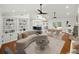 Open living space features built-in shelving, modern lighting, and seamless flow to the kitchen and dining areas at 13004 Bell Creek Chase, Riverview, FL 33569