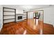 An open concept living room with hardwood floors, a fireplace, built-in shelves, and staircase at 13004 Bell Creek Chase, Riverview, FL 33569