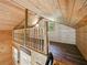 Charming loft area featuring wood-paneled walls, hardwood flooring, and natural light from quaint windows at 13004 Bell Creek Chase, Riverview, FL 33569