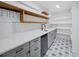 Butlers pantry with modern cabinetry, plenty of counterspace and open wooden shelving at 13004 Bell Creek Chase, Riverview, FL 33569