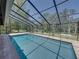 This is a wider angle of the pool and screened-in enclosure in the backyard at 13004 Bell Creek Chase, Riverview, FL 33569