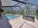 This is a wider angle of the pool, hot tub and screened-in enclosure in the backyard at 13004 Bell Creek Chase, Riverview, FL 33569