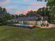Backyard view featuring a screened-in pool area, outdoor grill, and well-maintained lawn at 13004 Bell Creek Chase, Riverview, FL 33569