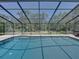 This is a center view of the pool and screened-in enclosure in the backyard at 13004 Bell Creek Chase, Riverview, FL 33569