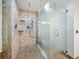 Shower features stone tile, glass doors, rainfall shower head and built-in shower niche at 13004 Bell Creek Chase, Riverview, FL 33569