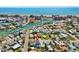 Panoramic aerial view of a coastal community showcasing the beach, harbor, homes, and streets with palm trees at 13117 4Th E St, Madeira Beach, FL 33708