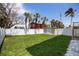Landscaped backyard featuring lush green grass, a privacy fence, and additional storage shed at 13117 4Th E St, Madeira Beach, FL 33708