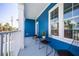 Charming balcony with comfortable seating, providing an inviting outdoor retreat with views of swaying palm trees at 13117 4Th E St, Madeira Beach, FL 33708
