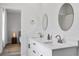 Bright bathroom with double sinks, modern fixtures, and easy access to the bedroom at 13117 4Th E St, Madeira Beach, FL 33708