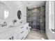 Bright modern bathroom features double sinks, quartz countertops, and a tiled shower at 13117 4Th E St, Madeira Beach, FL 33708