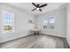 Bright bedroom with gray wood floors, desk and chair, natural light, and modern accents at 13117 4Th E St, Madeira Beach, FL 33708