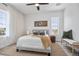 Sunlit bedroom boasts a ceiling fan, neutral colors, and stylish decor with a seating area at 13117 4Th E St, Madeira Beach, FL 33708
