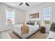 Bedroom with neutral color scheme, two big windows for plenty of sunlight, and a ceiling fan at 13117 4Th E St, Madeira Beach, FL 33708