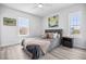This bedroom features ample natural light, modern floors and a ceiling fan at 13117 4Th E St, Madeira Beach, FL 33708