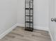 An empty walk-in closet features wood shelving and light wood flooring at 13117 4Th E St, Madeira Beach, FL 33708
