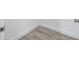 Close up of neutral-toned hardwood floors with white baseboards at 13117 4Th E St, Madeira Beach, FL 33708