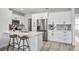 Modern kitchen with sleek white cabinets, stainless steel appliances, and a stylish breakfast bar with comfortable seating at 13117 4Th E St, Madeira Beach, FL 33708