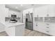 Modern kitchen features white cabinets, stainless steel appliances, and a stylish backsplash at 13117 4Th E St, Madeira Beach, FL 33708