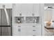 Modern kitchen features stainless steel appliances, white cabinets, and sleek countertops at 13117 4Th E St, Madeira Beach, FL 33708