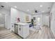 Bright and open living room featuring modern decor, recessed lighting, and an island with sink at 13117 4Th E St, Madeira Beach, FL 33708