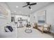 Bright living room with open floor plan with modern decor, plush seating, and sleek ceiling fan at 13117 4Th E St, Madeira Beach, FL 33708