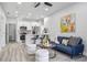 Bright, open-concept living space with a modern kitchen, stylish furnishings, and light, wood-look floors at 13117 4Th E St, Madeira Beach, FL 33708