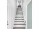 Contemporary stairway with white risers, wood treads and white railings at 13117 4Th E St, Madeira Beach, FL 33708
