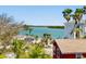 Stunning waterfront view overlooking tranquil turquoise waters, lush greenery, and palm trees adding a tropical touch at 13117 4Th E St, Madeira Beach, FL 33708