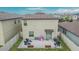 An aerial view of the fenced in backyard with paver patio, grill, and outdoor seating at 15718 Fort Island Pl, Sun City Center, FL 33573