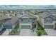 Aerial view of a two-story home with a well-kept lawn and landscaping, in a residential community at 15718 Fort Island Pl, Sun City Center, FL 33573