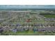 Explore this vibrant residential area from above, with houses nestled amongst lush greenery and clear streets at 15718 Fort Island Pl, Sun City Center, FL 33573