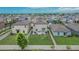 Aerial view of home showcasing the spacious backyard, patio furniture and surrounding neighborhood at 15718 Fort Island Pl, Sun City Center, FL 33573