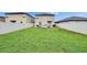 Expansive backyard features a well-maintained lawn, full privacy fence, and patio area with furnishings at 15718 Fort Island Pl, Sun City Center, FL 33573