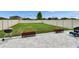 Backyard area with patio pavers, outdoor seating, grill, garden bed, and green space at 15718 Fort Island Pl, Sun City Center, FL 33573