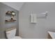 Bathroom with a toilet, shelves, decorative items, and towel bar at 15718 Fort Island Pl, Sun City Center, FL 33573