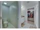 Clean bathroom with a toilet, sink, and access to a walk-in closet at 15718 Fort Island Pl, Sun City Center, FL 33573