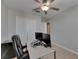 Bedroom featuring a work desk with dual monitors, closet and a ceiling fan at 15718 Fort Island Pl, Sun City Center, FL 33573