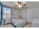 This charming bedroom features a full sized bed, bright natural light, and classic white trim at 15718 Fort Island Pl, Sun City Center, FL 33573