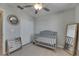 Light and airy bedroom featuring a closet, a mirror and a baby crib at 15718 Fort Island Pl, Sun City Center, FL 33573