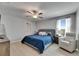 A serene bedroom features a tufted headboard, plush bedding, a cozy armchair, and lots of natural light at 15718 Fort Island Pl, Sun City Center, FL 33573