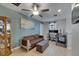 Comfortable bedroom featuring a ceiling fan, a cozy sofa, and a functional workspace at 15718 Fort Island Pl, Sun City Center, FL 33573
