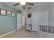 Light and airy bedroom featuring a closet, a mirror and a baby crib at 15718 Fort Island Pl, Sun City Center, FL 33573