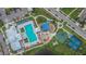 Aerial view of a community center, pools, playground, basketball and bocce ball courts at 15718 Fort Island Pl, Sun City Center, FL 33573