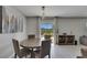 Bright dining area with a table and seating for four with a cabinet nearby at 15718 Fort Island Pl, Sun City Center, FL 33573