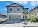 Charming two-story home with a well-maintained lawn, inviting entrance, and neutral color palette at 15718 Fort Island Pl, Sun City Center, FL 33573