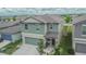 Two story home has a two car garage, front garden, and covered front porch at 15718 Fort Island Pl, Sun City Center, FL 33573