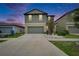 Two-story home with a two-car garage, lush landscaping, and a welcoming front yard at 15718 Fort Island Pl, Sun City Center, FL 33573