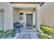 Inviting front entrance with a bench, potted plants, and stylish decor at 15718 Fort Island Pl, Sun City Center, FL 33573