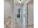 The bright hallway features tile flooring and leads to a cozy bedroom with a stylish dresser at 15718 Fort Island Pl, Sun City Center, FL 33573